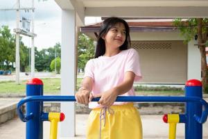 Young girl doing exercise with colorful equipment exercise. photo