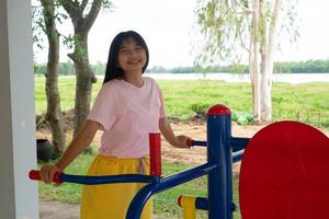 Young girl doing exercise with colorful equipment exercise. photo