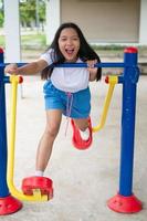 Young girl doing exercise with colorful equipment exercise. photo