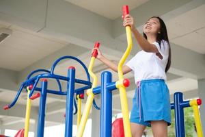 Young girl doing exercise with colorful equipment exercise. photo
