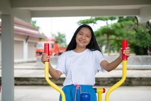 Young girl doing exercise with colorful equipment exercise. photo