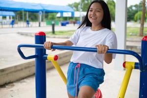 Young girl doing exercise with colorful equipment exercise. photo