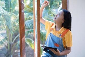 The girl using laptop sitting at windows ,at home. photo