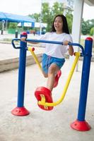 Young girl doing exercise with colorful equipment exercise. photo