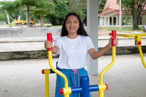 Young girl doing exercise with colorful equipment exercise. photo