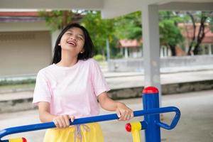 Young girl doing exercise with colorful equipment exercise. photo