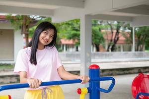 Young girl doing exercise with colorful equipment exercise. photo