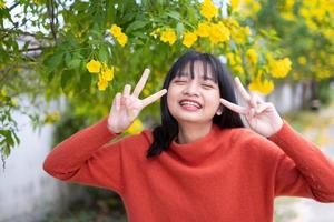 Portrait young girl with yellow flowers, Asian girl. photo