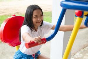 Young girl doing exercise with colorful equipment exercise. photo