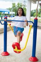 Young girl doing exercise with colorful equipment exercise. photo