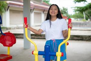 Young girl doing exercise with colorful equipment exercise. photo