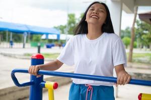 Young girl doing exercise with colorful equipment exercise. photo