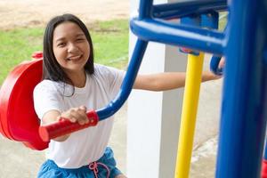 Young girl doing exercise with colorful equipment exercise. photo