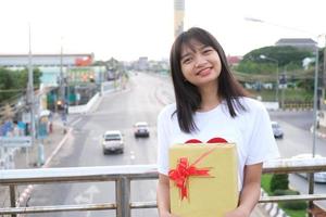 Happy young girl with gift box. photo