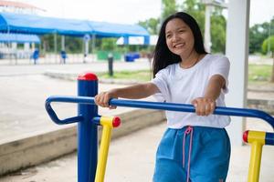 Young girl doing exercise with colorful equipment exercise. photo