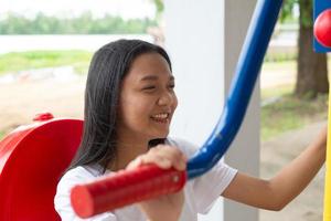 Young girl doing exercise with colorful equipment exercise. photo