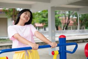 Young girl doing exercise with colorful equipment exercise. photo