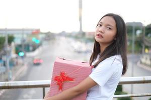 Happy young girl with gift box. photo