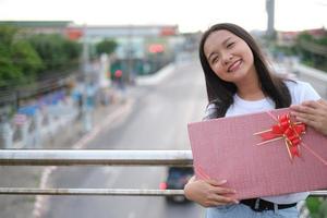 Happy young girl with gift box. photo