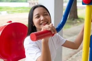 Young girl doing exercise with colorful equipment exercise. photo