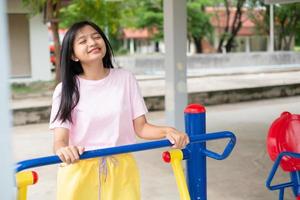 Young girl doing exercise with colorful equipment exercise. photo