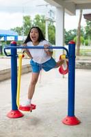 Young girl doing exercise with colorful equipment exercise. photo