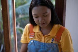 The girl using laptop sitting at windows ,at home. photo