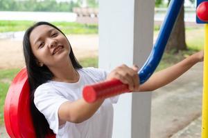 Young girl doing exercise with colorful equipment exercise. photo