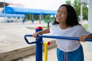 Young girl doing exercise with colorful equipment exercise. photo