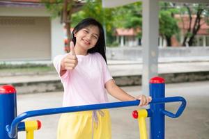 Young girl doing exercise with colorful equipment exercise. photo