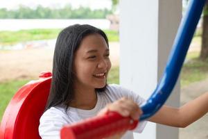 Young girl doing exercise with colorful equipment exercise. photo