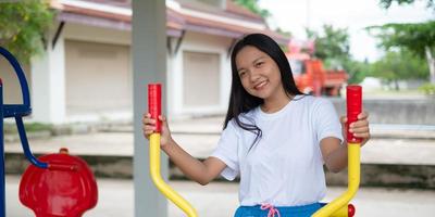 Young girl doing exercise with colorful equipment exercise. photo