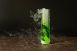 Dry ice reacts with green water to produce smoke. photo