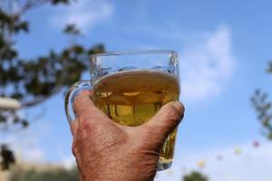 On the table in the restaurant a glass of fresh and cold beer. photo