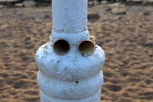 Old glasses are lying in the city park on the seashore. photo