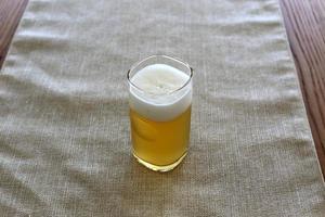 On the table in the restaurant a glass of fresh and cold beer. photo