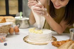 Close up of Young beautiful woman is baking in her kitchen , bakery and coffee shop business photo