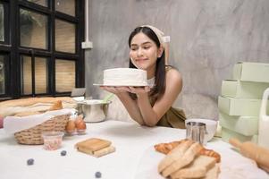 Young beautiful woman is baking in her kitchen , bakery and coffee shop business photo