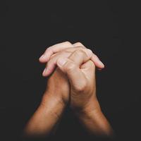 Close up Asian christian woman hands person pray and worship for thank god in church with black background, The concept for faith, spirituality and religion photo