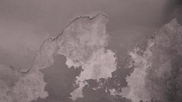 The old cement wall was weathered, the surface was scratched, the surface was scratched and damaged. For a mysterious retro-conservative background. photo