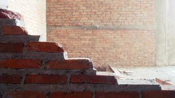 Unconventional building site The masonry was neglected, irresponsible, not progressing, only half finished. Some parts, the walls had rough surfaces. photo