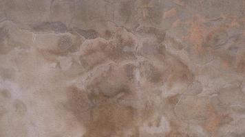 The old cement wall was weathered, the surface was scratched, the surface was scratched and damaged. For a mysterious retro-conservative background. photo