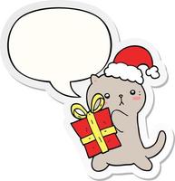 cute cartoon cat carrying christmas present and speech bubble sticker vector