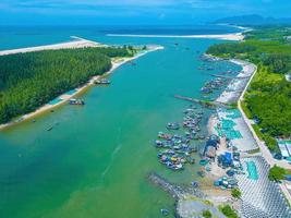 Beautiful blue skyline panoramic in Loc An Canal. Scenery landscape of fishing port with tsunami protection concrete blocks. Cityscape and boats in the sea. Loc An village near Vung Tau City. photo