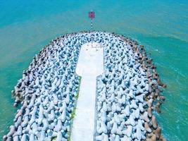 Beautiful blue skyline panoramic in Loc An Canal. Scenery landscape of fishing port with tsunami protection concrete blocks. Cityscape and boats in the sea. Loc An village near Vung Tau City. photo