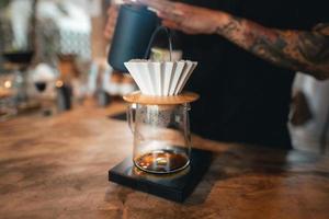 Closeup of hands barista make coffee photo