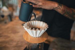 Closeup of hands barista make coffee photo