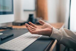 Man working on computer desk at home office photo