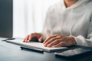 Man working on computer desk at home office photo