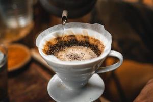 Closeup of hands barista make coffee photo